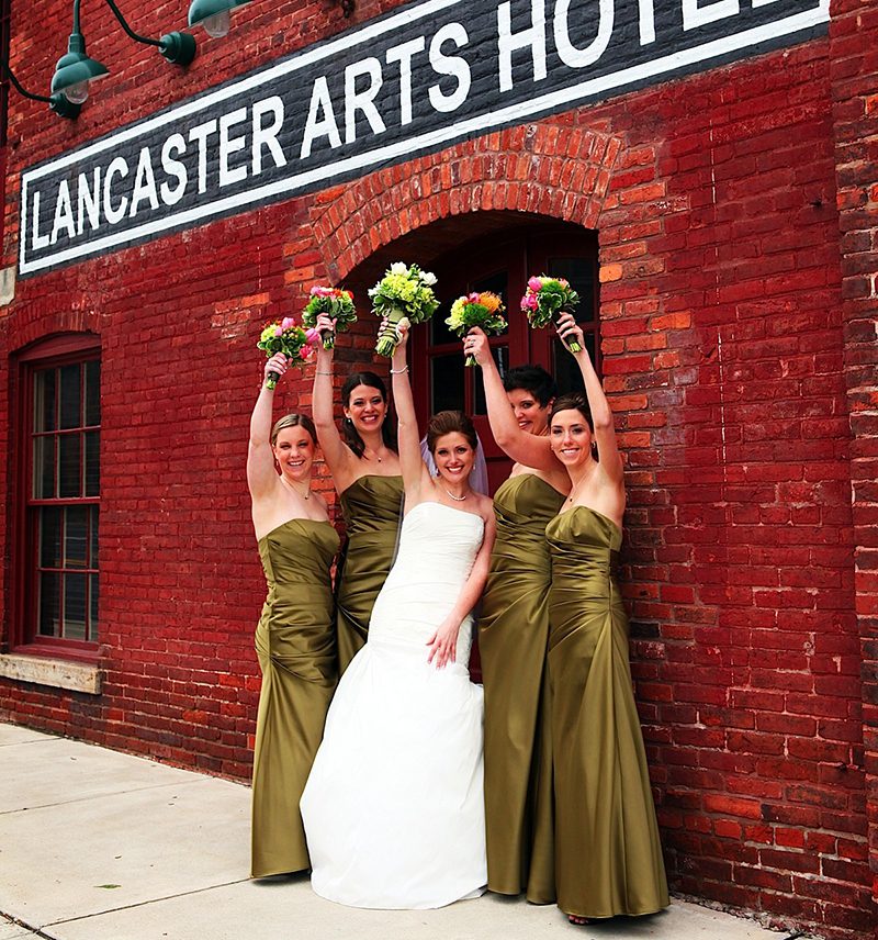 wedding party holding up boquets