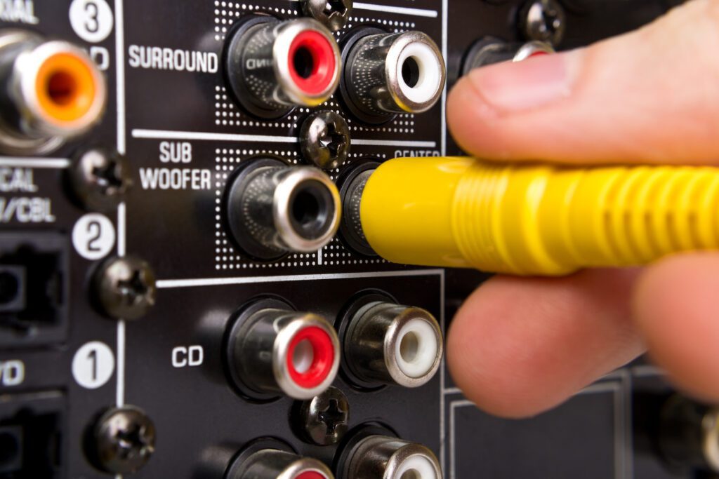 hand plugging in an AV cable